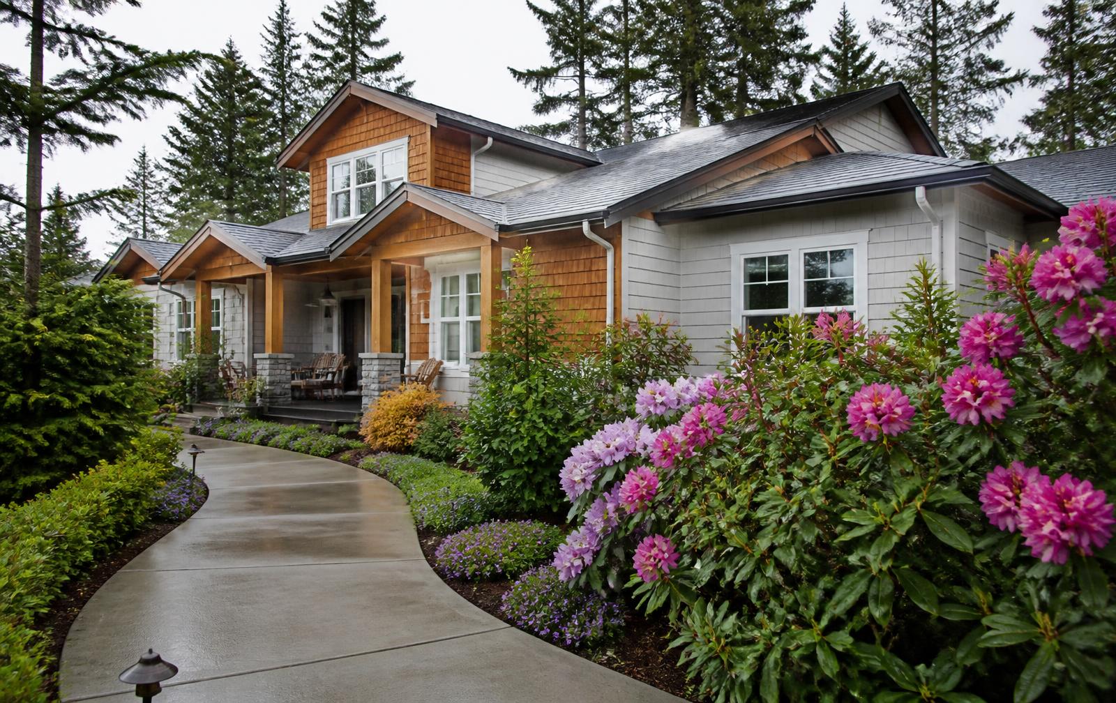 West Coast family home with a clean roof, bright siding and washed walkway